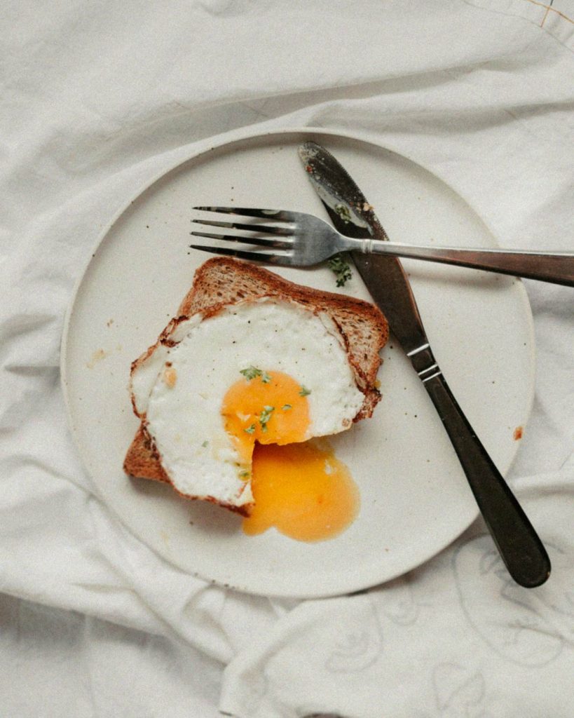 A homemade plate of eggs and bread for a natural breakfast, mindful eating, and self-care.